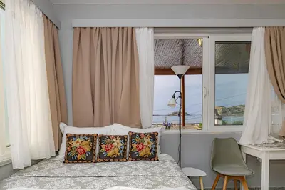 a bedroom with a bed and a window at Barbara's Apartments in Vrachonisída touArchangélou