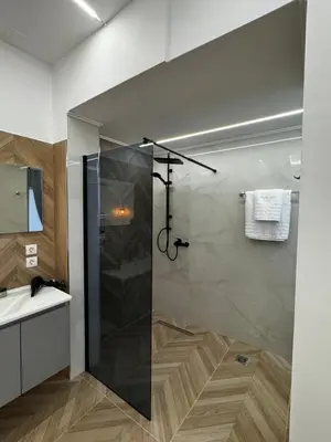 a bathroom with a shower and a sink at Valsamo Suite in Ialyssos