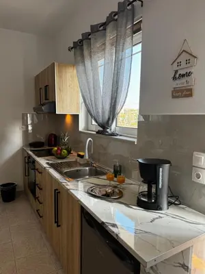 a kitchen with a sink and a counter top at Valsamo Suite in Ialyssos