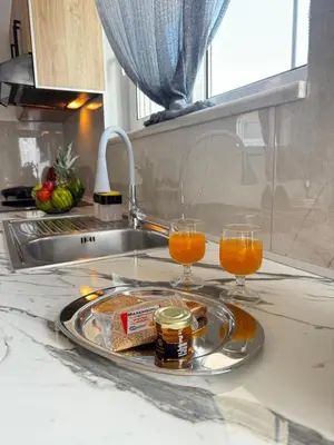 a plate of food and two glasses of orange juice at Valsamo Suite in Ialyssos