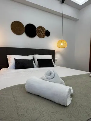 a bedroom with a bed with a white towel on it at Valsamo Suite in Ialyssos