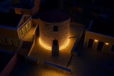 a building with a clock tower at night at Wuthering Mill in Symi