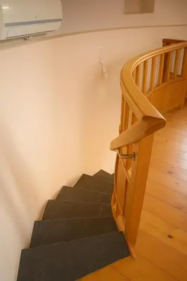 a set of stairs in a room with a stair case at Wuthering Mill in Symi