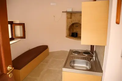 a small kitchen with a sink and a stove at Wuthering Mill in Symi