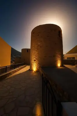 a building with lights on the side of it at Wuthering Mill in Symi