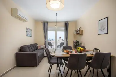 a living room with a table and a couch at Palmtrees Apartments in Afantou