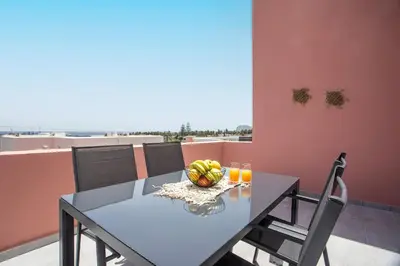 a dining room table with a bowl of fruit and juice at Palmtrees Apartments in Afantou