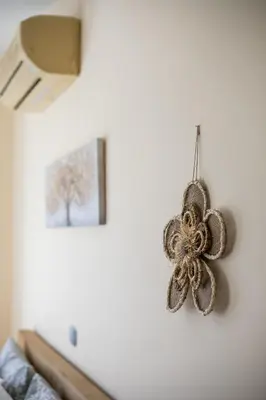 a decoration hanging on a wall in a living room at Palmtrees Apartments in Afantou