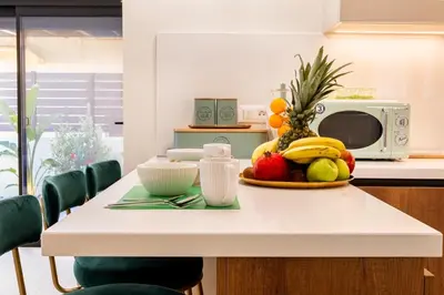a table with a bowl of fruit on it at NiMar luxury city villa with jacuzzi in Rhodes Town