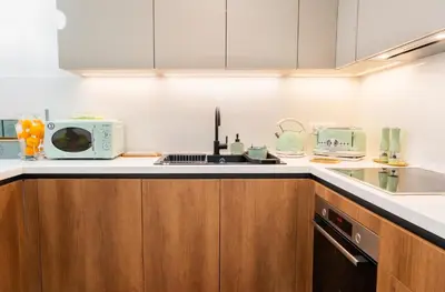 a kitchen with a sink and a microwave at NiMar luxury city villa with jacuzzi in Rhodes Town