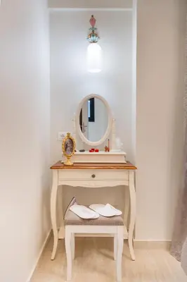 a dressing table with a mirror and a stool at NiMar luxury city villa with jacuzzi in Rhodes Town