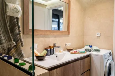 a bathroom with a sink and a washing machine at NiMar luxury city villa with jacuzzi in Rhodes Town