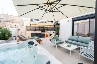 a jacuzzi tub in the middle of a patio at NiMar luxury city villa with jacuzzi in Rhodes Town