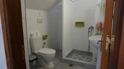 a small bathroom with a toilet and a sink at Sugarcubes by Evagstays in Faliraki