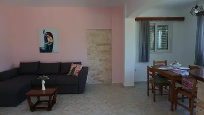 a living room with a couch and a table at Sugarcubes by Evagstays in Faliraki