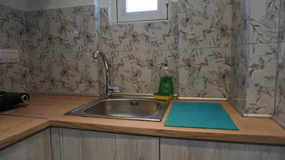 a kitchen sink with a green sponge next to it at Sugarcubes by Evagstays in Faliraki