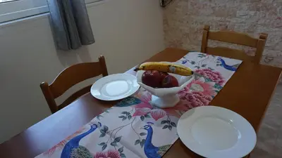 a table with a banana and a bowl of fruit at Sugarcubes by Evagstays in Faliraki