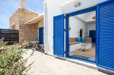 a blue door of a house with a patio at Villa Milla in Gennadi