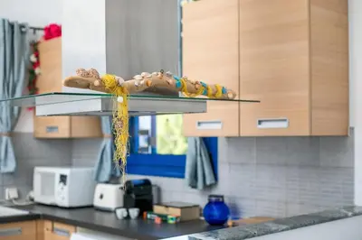 a kitchen counter with a glass shelf in a kitchen at Villa Milla in Gennadi