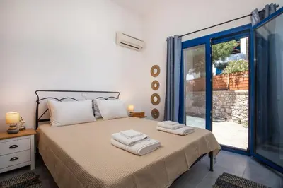 a bedroom with a bed with two towels on it at Villa Milla in Gennadi