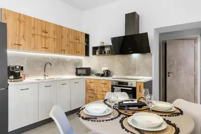 a kitchen with a table and chairs in a kitchen at VaSteka House 2 in Haraki