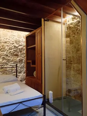a bedroom with a glass shower and a bed at St John house Castle City in Rhodes Town