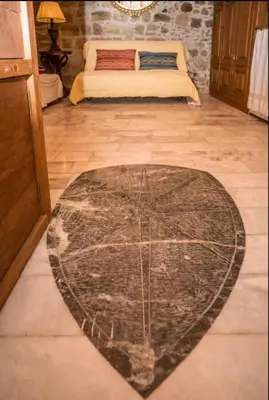 a room with a rug on the floor with a bed at St John house Castle City in Rhodes Town