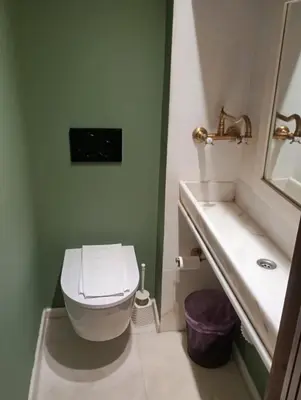 a bathroom with a white toilet and a sink at St John house Castle City in Rhodes Town