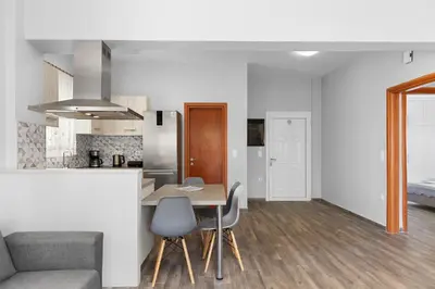 a kitchen and living room with a table and chairs at City Central Appartment in Rhodes Town