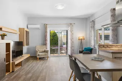 a living room with a table and chairs and a television at City Central Appartment in Rhodes Town