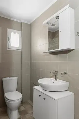 a bathroom with a white toilet and a sink at City Central Appartment in Rhodes Town