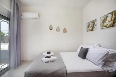 a white bedroom with a bed with towels on it at Casa Platoni in Apolakkiá