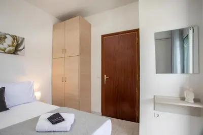a bedroom with a bed and a wooden cabinet at Casa Platoni in Apolakkiá