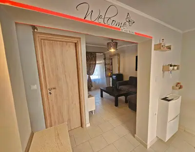 a welcome sign above a door in a living room at My Summerhouse with jacuzzi in Kremasti