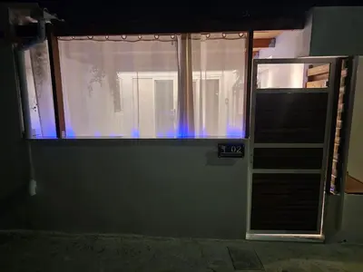 a room with a window and a staircase with blue lights at My Summerhouse with jacuzzi in Kremasti