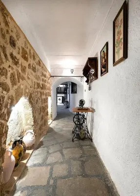 a hallway with a stone wall and a table at Levent Traditional Villa Rhodes Castle in Rhodes Town
