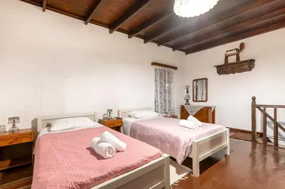 a bedroom with two beds with pink sheets at Levent Traditional Villa Rhodes Castle in Rhodes Town