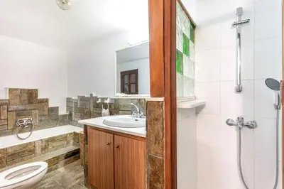 a bathroom with a sink and a toilet and a shower at Levent Traditional Villa Rhodes Castle in Rhodes Town