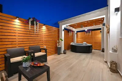 a large room with a tub and a table at Harmony Studio Apartment in Ialyssos