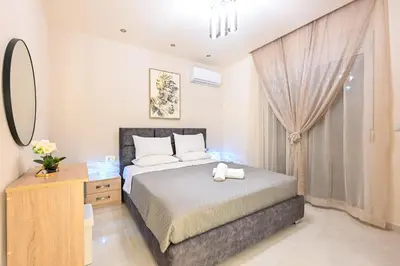 a bedroom with a bed and a dresser and a window at Harmony Studio Apartment in Ialyssos