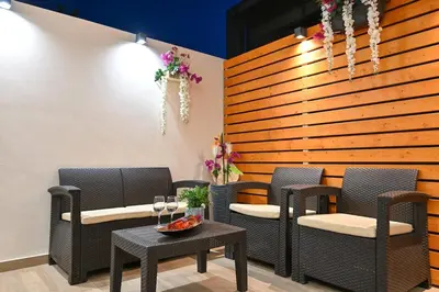 a restaurant with chairs and a table and a wooden wall at Harmony Studio Apartment in Ialyssos