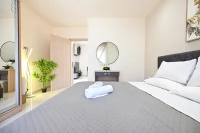 a bedroom with a large bed with a towel on it at Harmony Studio Apartment in Ialyssos