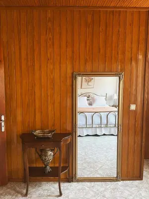 a mirror in a room with a bed and a table at Margo Traditional House in Symi