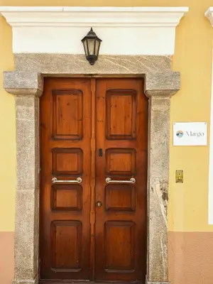 a wooden door with a light on top of it at Margo Traditional House in Symi