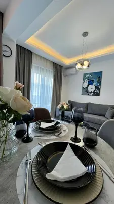 a living room with a table with plates and utensils at Apartamento Elegante de Chris in Rhodes Town