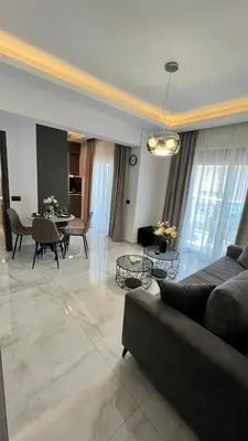 a living room with a couch and a table at Apartamento Elegante de Chris in Rhodes Town
