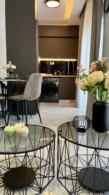 a living room with two tables and a kitchen at Apartamento Elegante de Chris in Rhodes Town