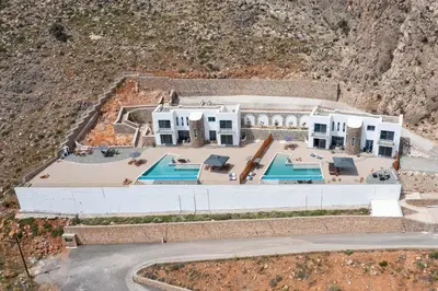 an aerial view of a house with two swimming pools at Aitheria Lindos Villa in Líndos