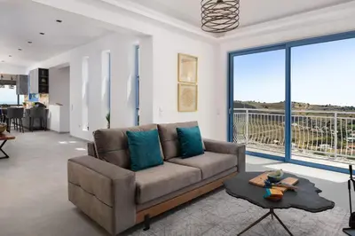 a living room with a couch and a table at Aitheria Lindos Villa in Líndos