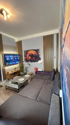 a living room with a large bed and a couch at Ciel Apartment in Rhodes Town